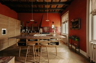 A wood kitchen with deep red walls