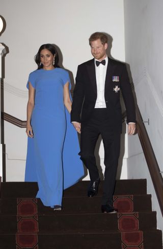 Prince Harry and Meghan Markle descending a staircase