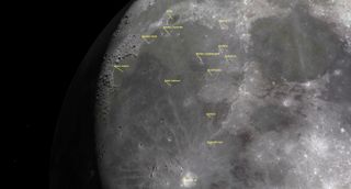 a close up of the moon shows detailed craters labeled with their names.
