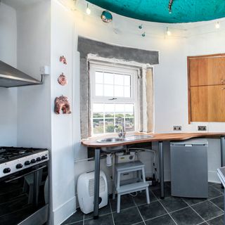 lighthouse kitchen room with tiled flooring and white walls