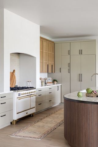 modern farmhouse kitchen with rattan cabinets and fluted kitchen island by Lindye Galloway