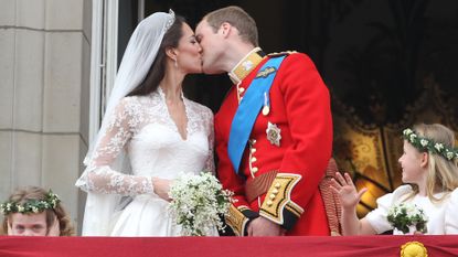 Prince William and his bride Catherine Middleton kiss on the balcony of Buckingham Palace following their Royal Wedding