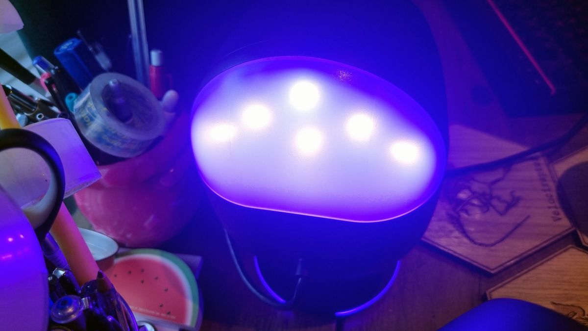 The back of the front left speaker of the SteelSeries Arena 9, showing the RGB lighting effect lit up in blue