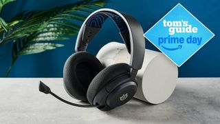 SteelSeries Arctis Nova 5 on table with plant in background with Tom's Guide Prime Day badge