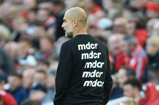 Manchester City manager Pep Guardiola wears a mdcr sweater in a game against Liverpool in October 2021.
