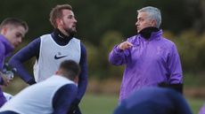 Tottenham striker Harry Kane speaks with new head coach Jose Mourinho at training