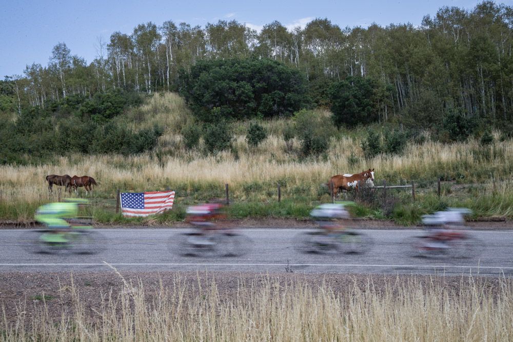 Riders pass by horses along the course