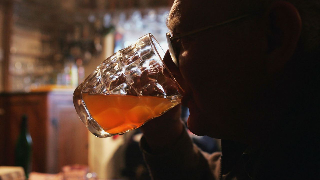 Man drinking a pint.