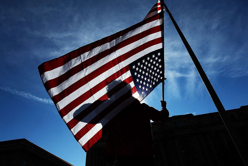 An Occupy DC protester holds an American flag upside down