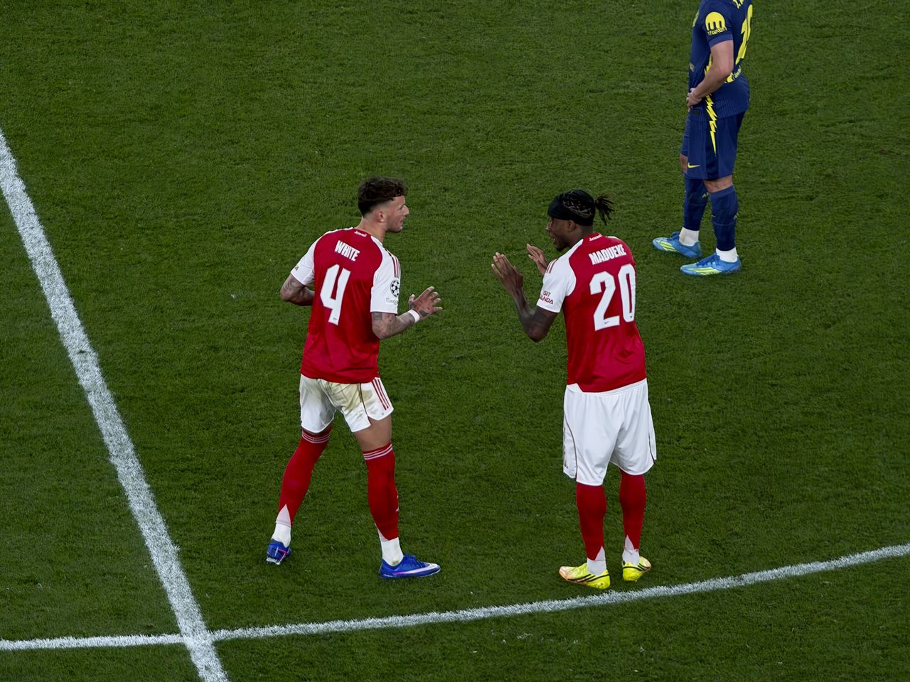 Action photos during a Champions League soccer match at Arsenal's Emirates stadium, taken with the Oppo Find X9 Ultra and teleconverter lens
