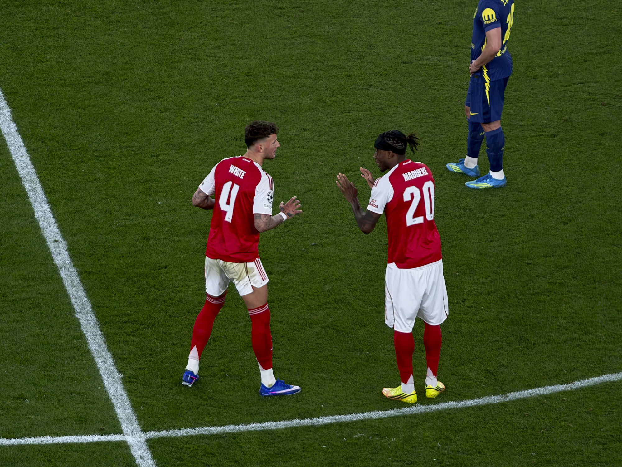 Action photos during a Champions League soccer match at Arsenal's Emirates stadium, taken with the Oppo Find X9 Ultra and teleconverter lens