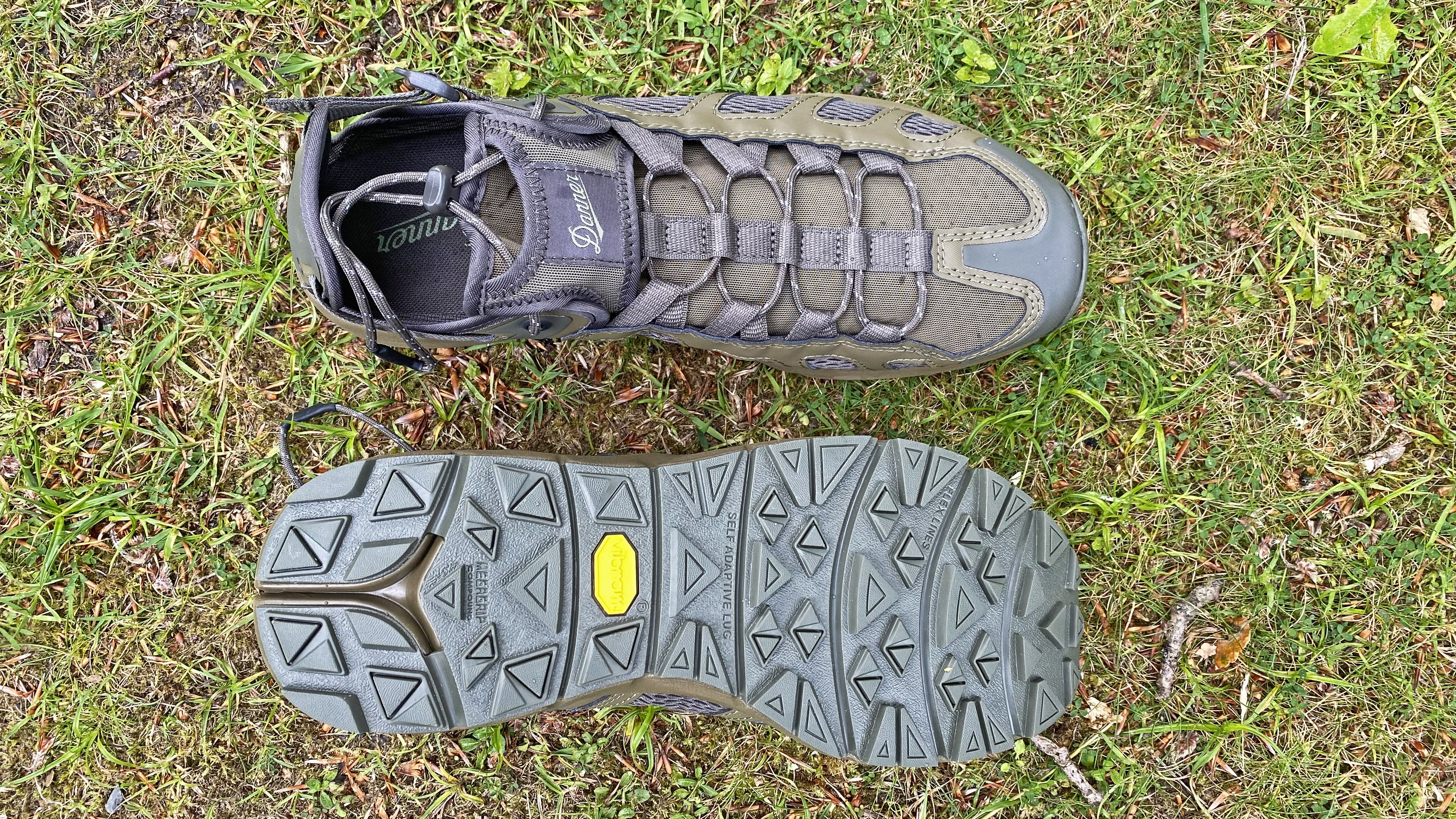 Danner Fullbore Sandals on grass, showing a top view and the Vibram Megagrip sole