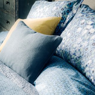 Floral-print pillows on a bed