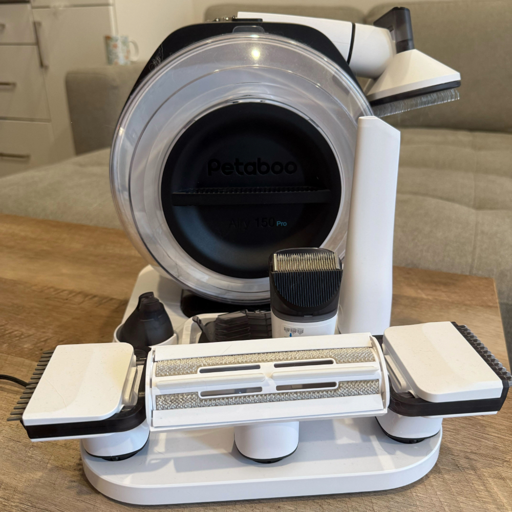 petaboo Cordless Dog Grooming Vacuum on a wooden table, one of the best vacuum cleaners for pet hair