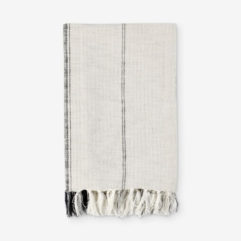 light gray throw blanket with dark gray stripe