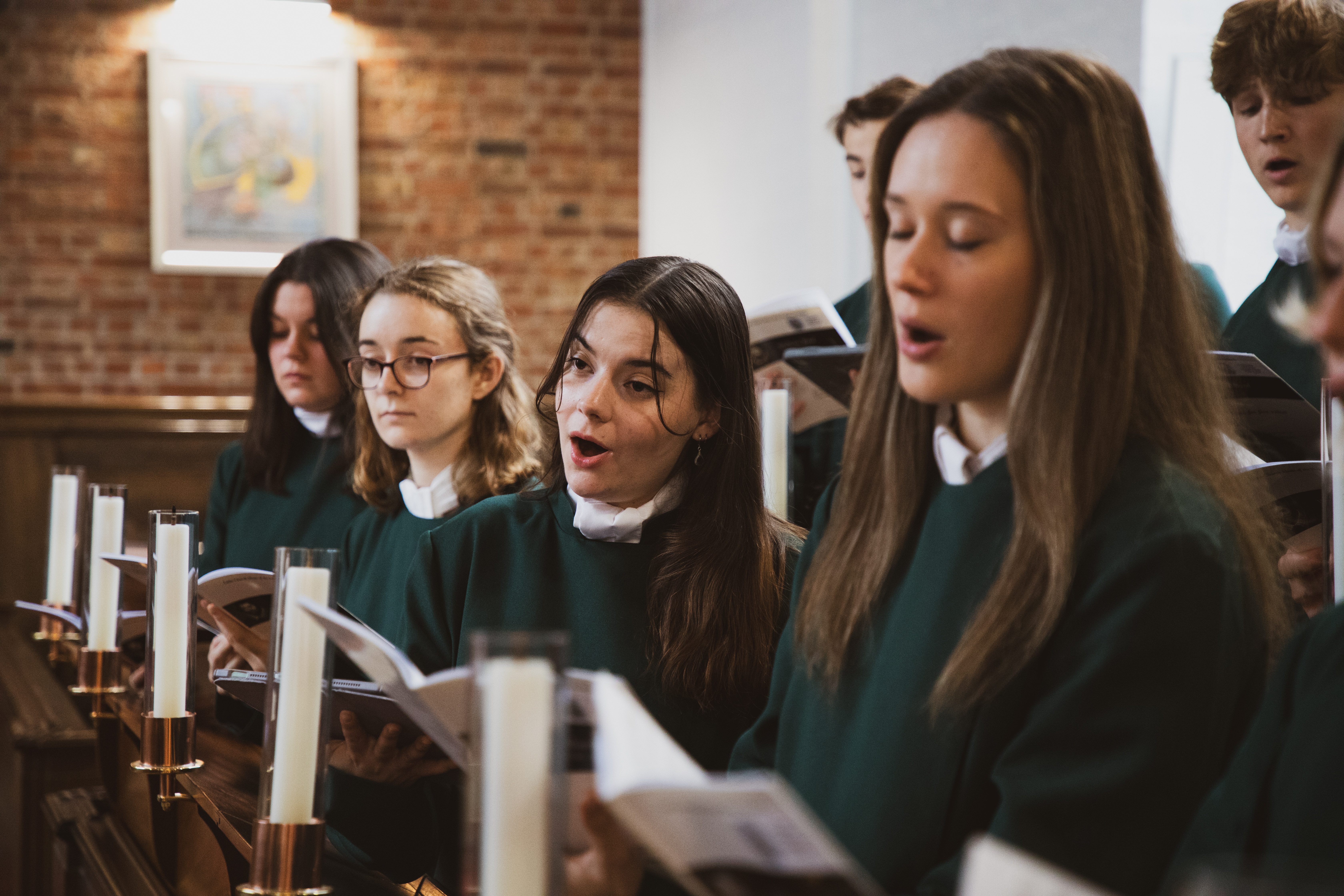 Four women singing in a church 