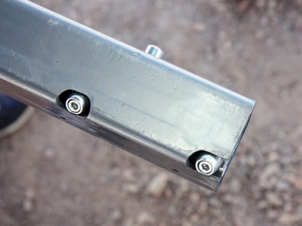 Closing the Lynx's quick-release lever wedges these two pins outwards against the inside of the receiver hitch for wiggle-free mounting