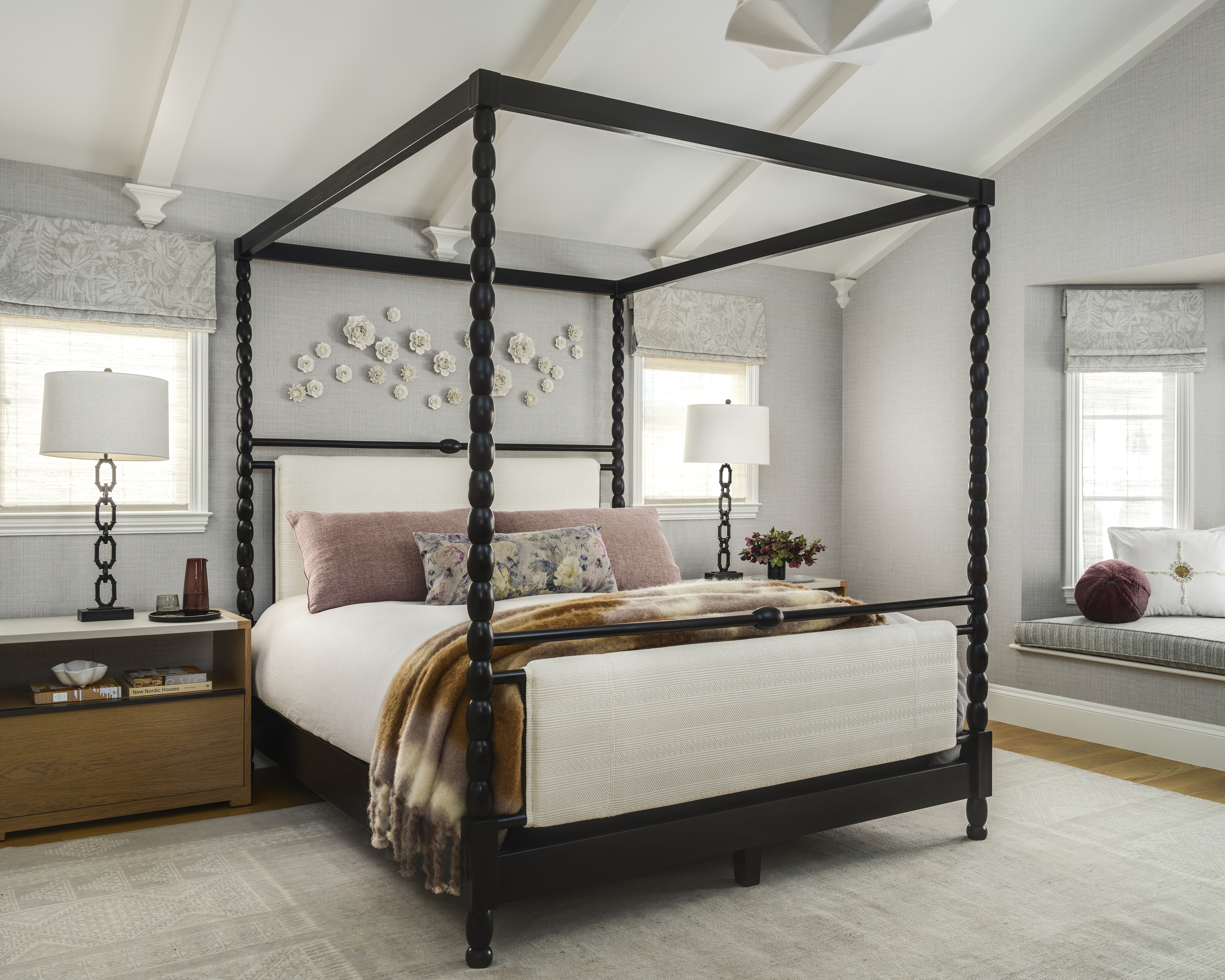 large gray bedroom with black canopy bed in the middle