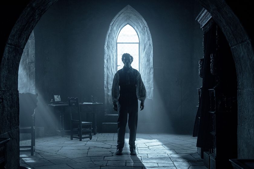 nicholas hoult&#039;s character, thomas, stands in a dark room. Just above his head is an arched window with a stream of white light coming through. There is shadow across his face so we can&#039;t really see his expression. He is looking ahead with the camera straight on.