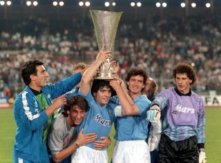 Diego Maradona and his Napoli team-mates celebrate with the UEFA Cup trophy after victory in the final over VfB Stuttgart in May 1989.