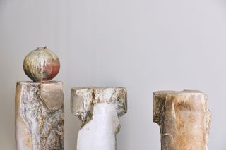 round vase and rocky plinths