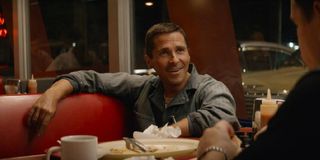 Ford v Ferrari Christian Bale smiles while sitting in a diner booth