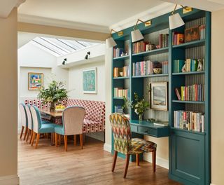 Blue painted custom shelving and desk with chair and dining banquette and table and chairs