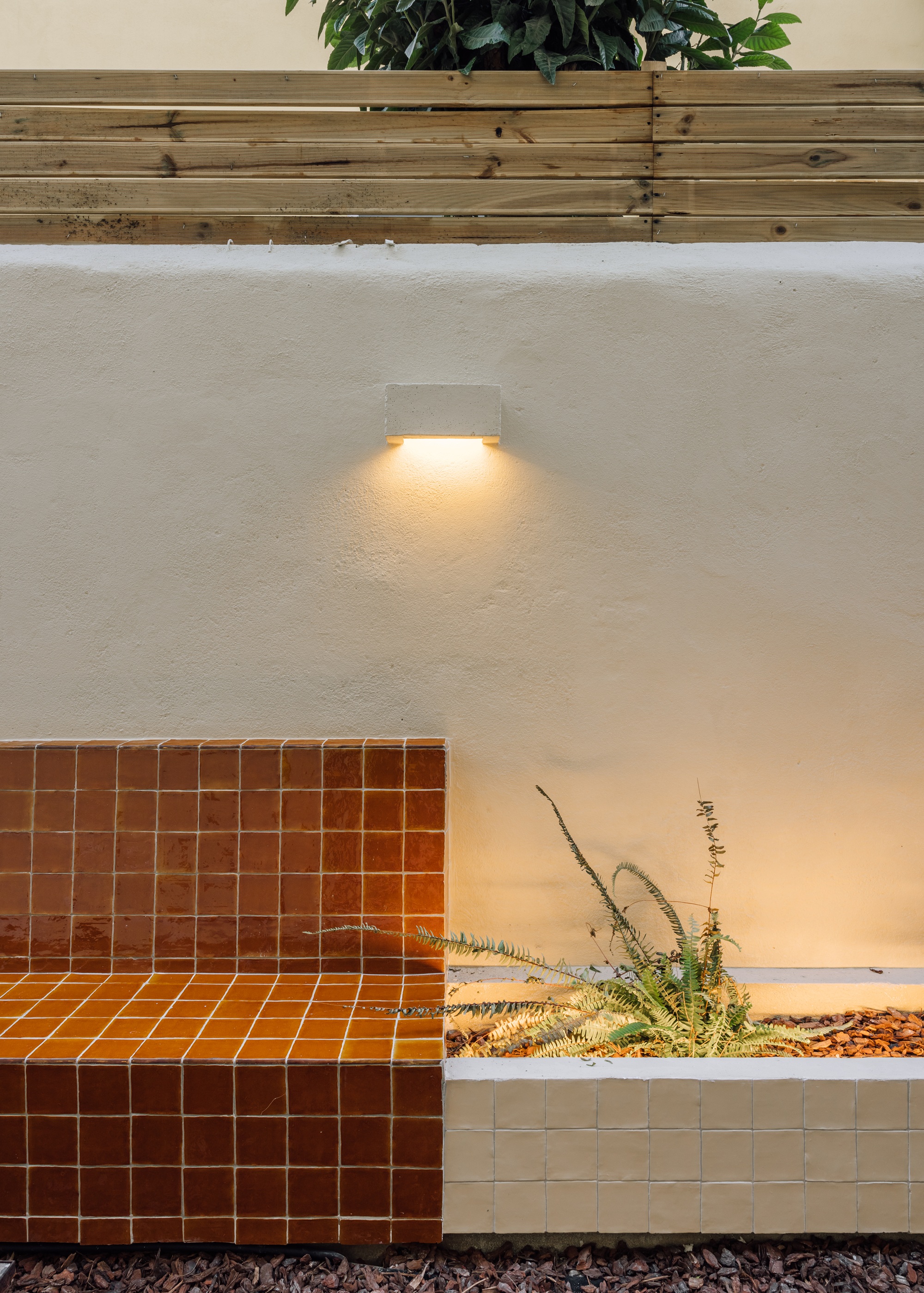 a garden with a tiled built in bench