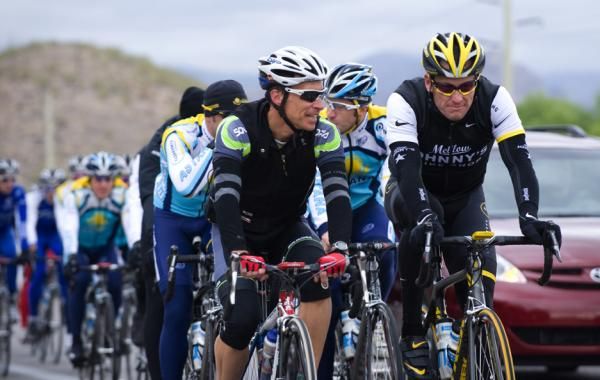 Lance Armstrong (right) chats with a local friend on a training ride.