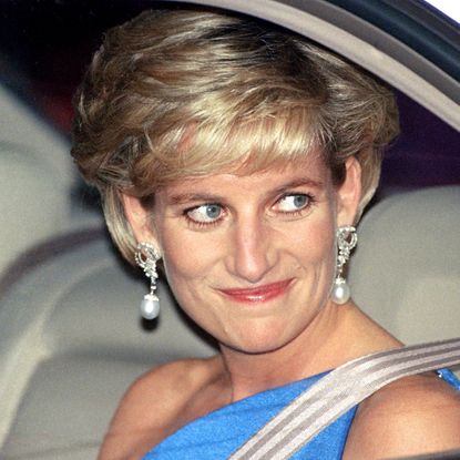 Princess Diana in a car wearing a blue gown and pearl drop earrings