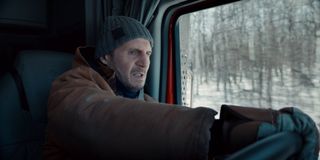 Liam Neeson driving with an intense look on his face in The Ice Road.