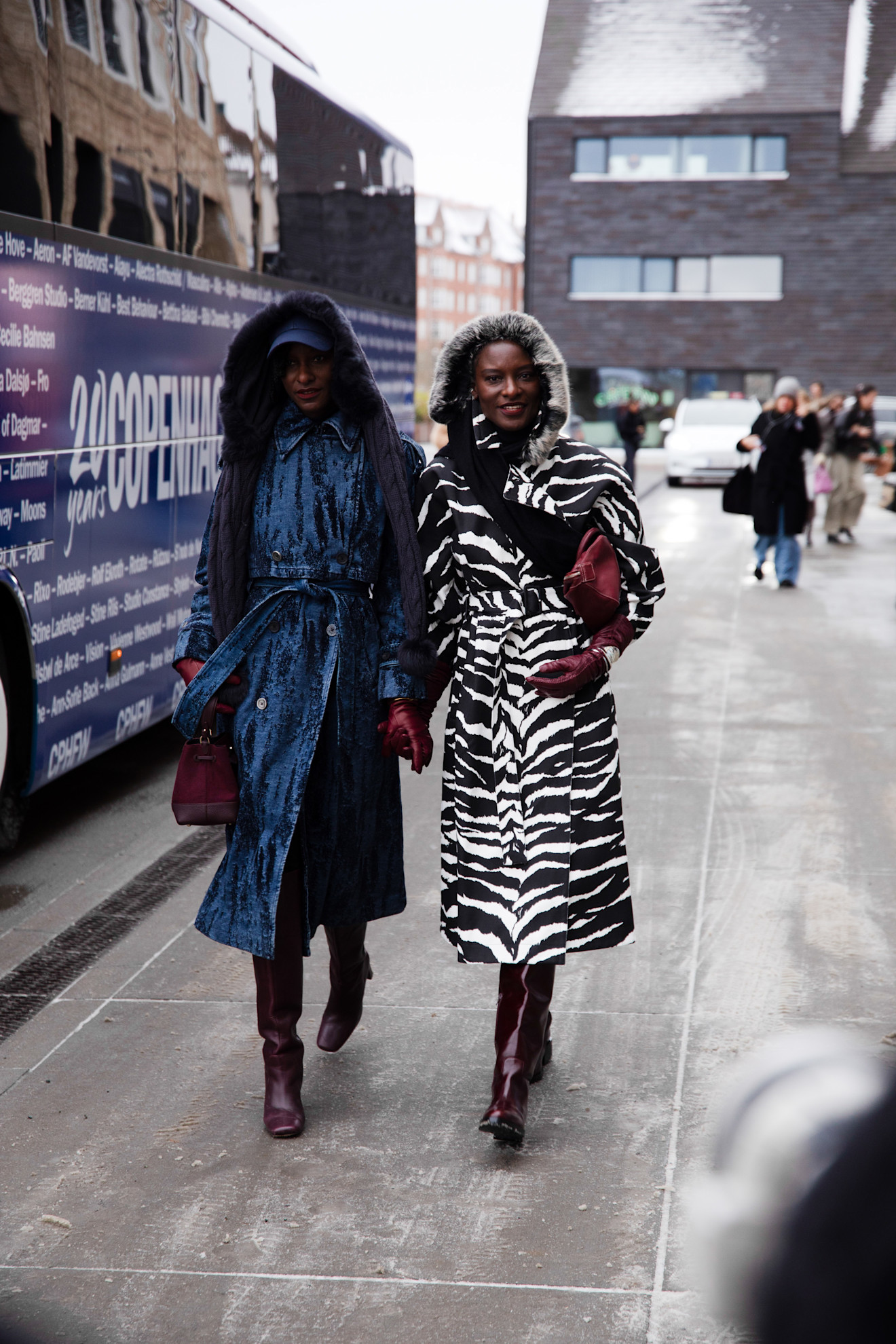two women at copenhagen fashion week wearing zebra print and sequin coats
