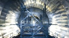 Engineer stand inside the KATRIN neutrino experiment at the Karlsruhe Institute of Technology in Germany.