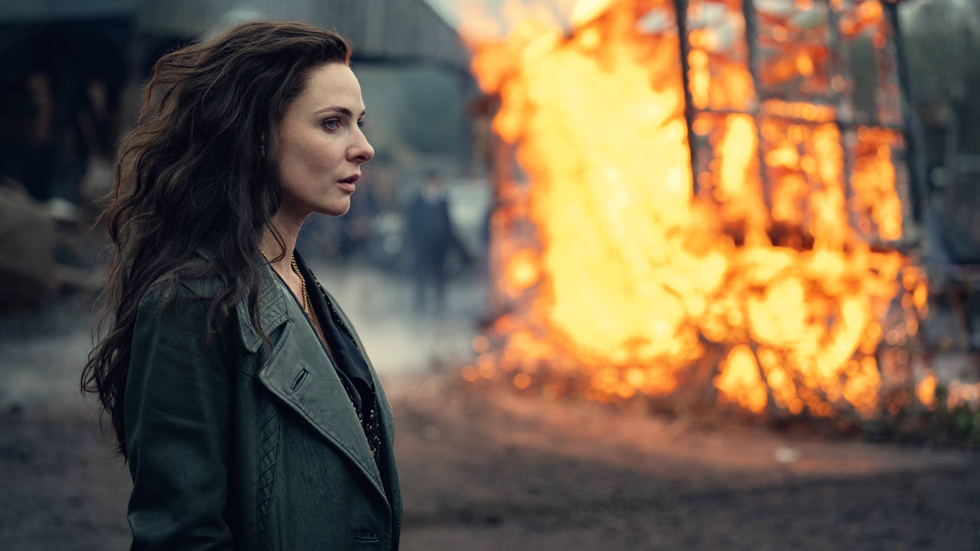 Rebecca Ferguson as Kaulo Chirklo standing in front of a fire in Peaky Blinders: The Immortal Man