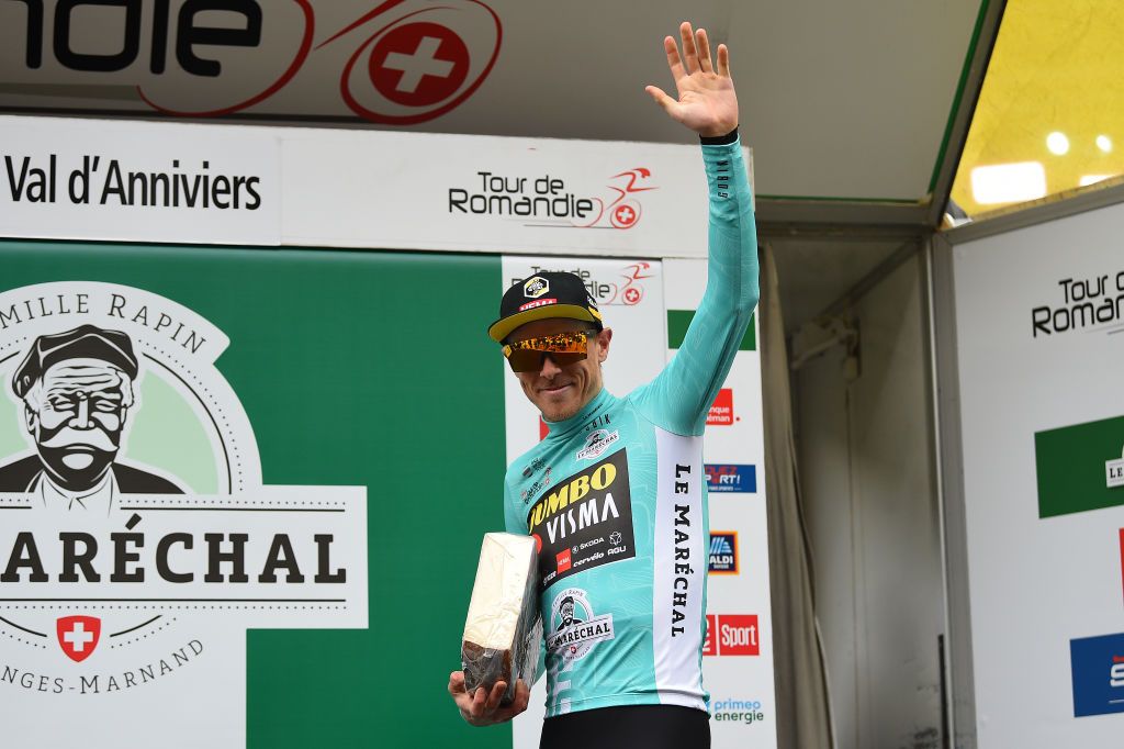 ZINAL VAL DANNIVIERS SWITZERLAND APRIL 30 Rohan Dennis of Australia and Team Jumbo Visma Turquoise Leader Jersey celebrates at podium with a cheese trophy during the 75th Tour De Romandie 2022 Stage 4 a 1801km stage from Aigle to Zinal Val dAnniviers 1664m TDR2022 on April 30 2022 in Zinal Val dAnniviers Switzerland Photo by Dario BelingheriGetty Images