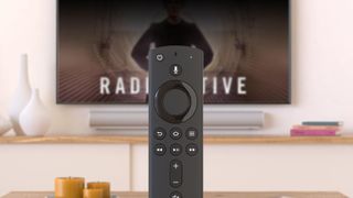 amazon fire tv remote in front of tv screen