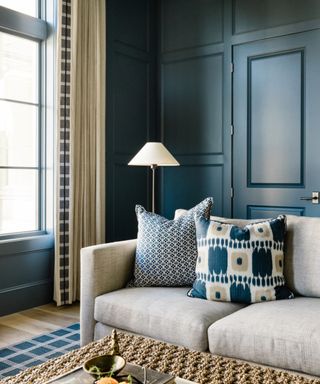 Living room with panelled walls painted in navy