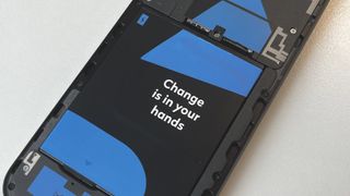 The Fairphone 5 with a transparent back on a white background