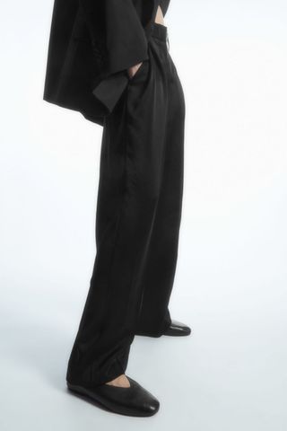 woman wearing wide leg trousers from the cos sale