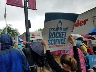 A girl holds up a rocket science-themed sign while marching in the March for Science demonstration in Washington D.C. on April 22, 2017.