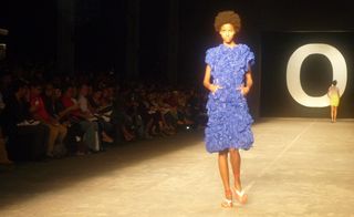 Female model wearing a ruffled blue dress