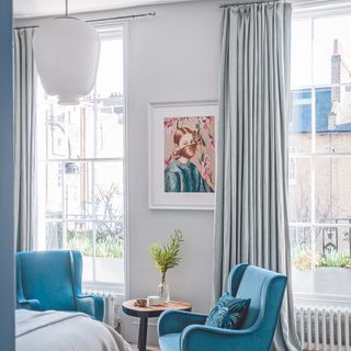 blue room with single grey curtains