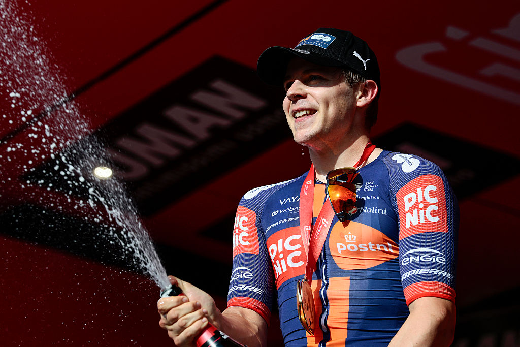 Team Picnic PostNL's Dutch rider Casper Van Uden celebrates on the podium after winning the 4th stage of the 108th Giro d'Italia cycling race 189kms from Alberobello to Lecce on May 13, 2025. (Photo by Luca Bettini / AFP)