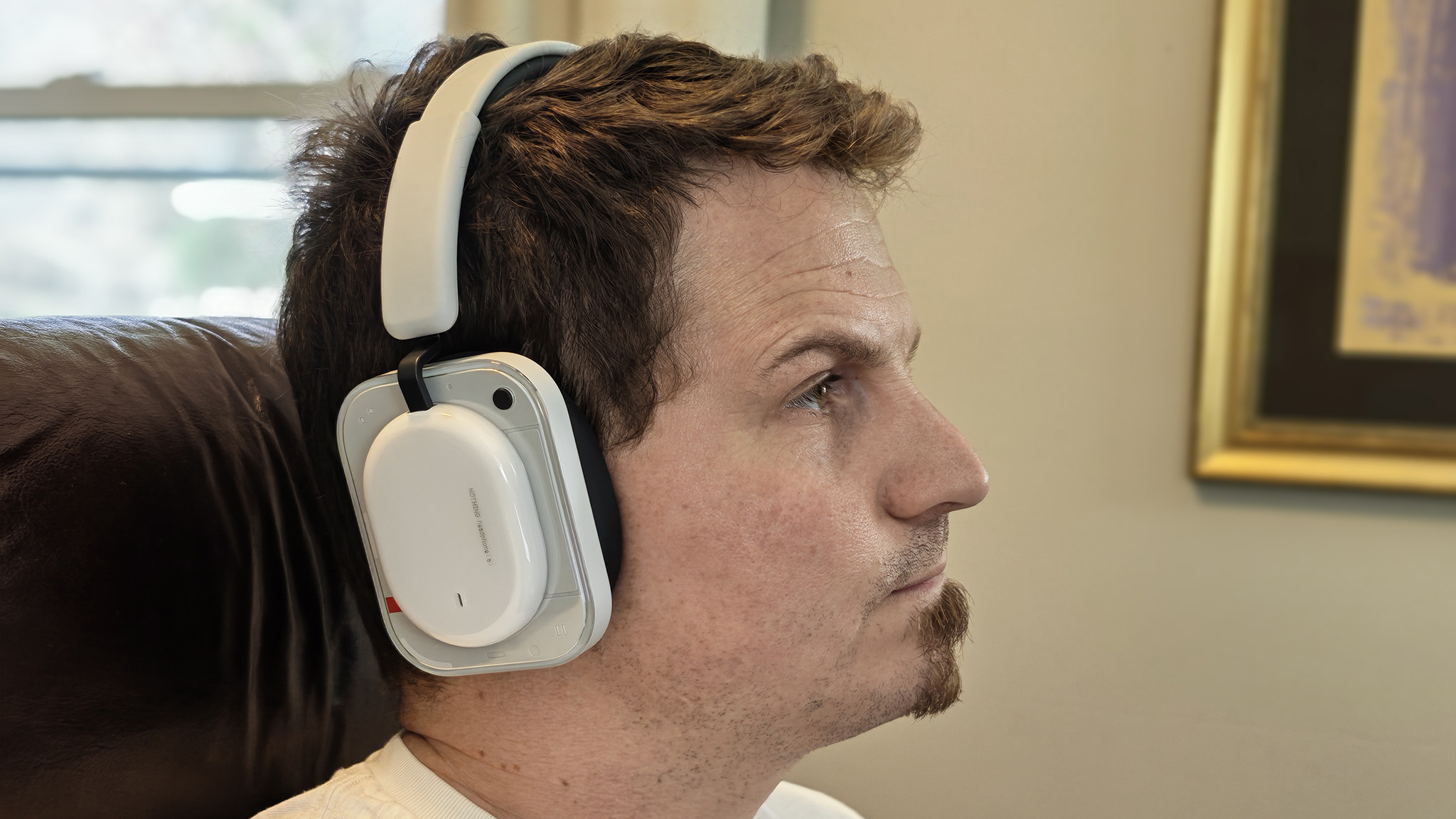 Wearing a pair of white Nothing Headphone (a)