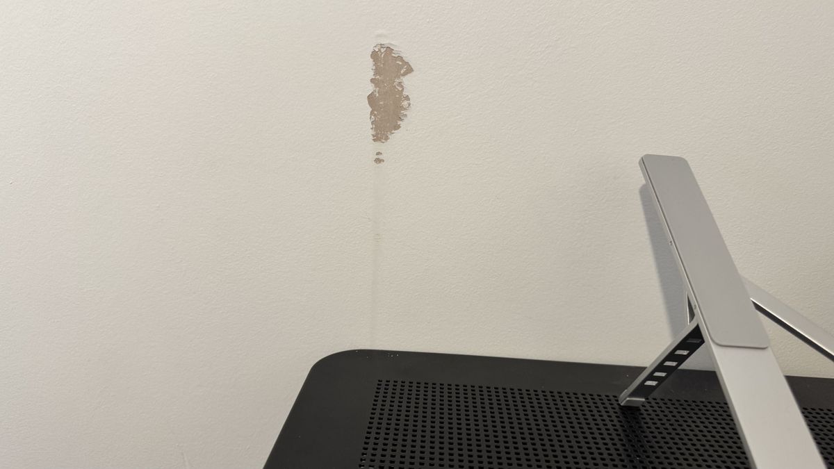 Damage in a white wall where a gaming desk scraped against it