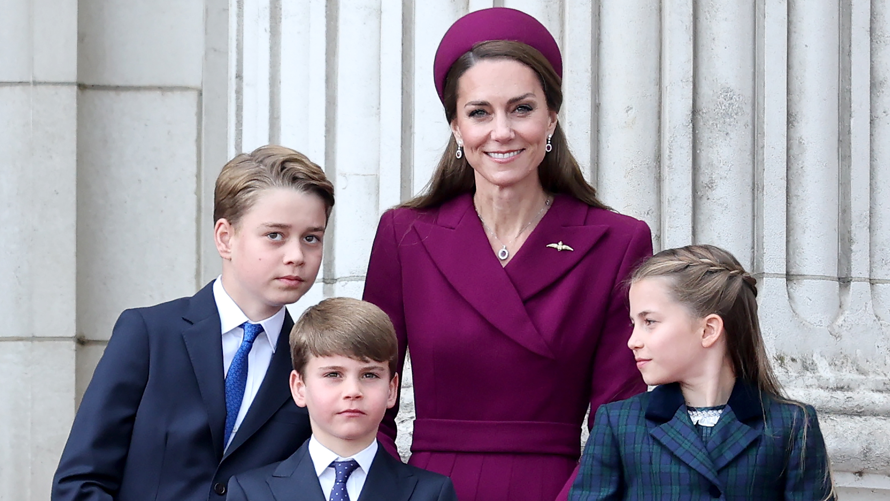 Prince George of Wales, Prince Louis of Wales, Catherine, Princess of Wales and Princess Charlotte of Wales watch the fly-past on the balcony of Buckingham Palace 