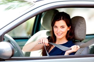 Woman putting on seatbelt