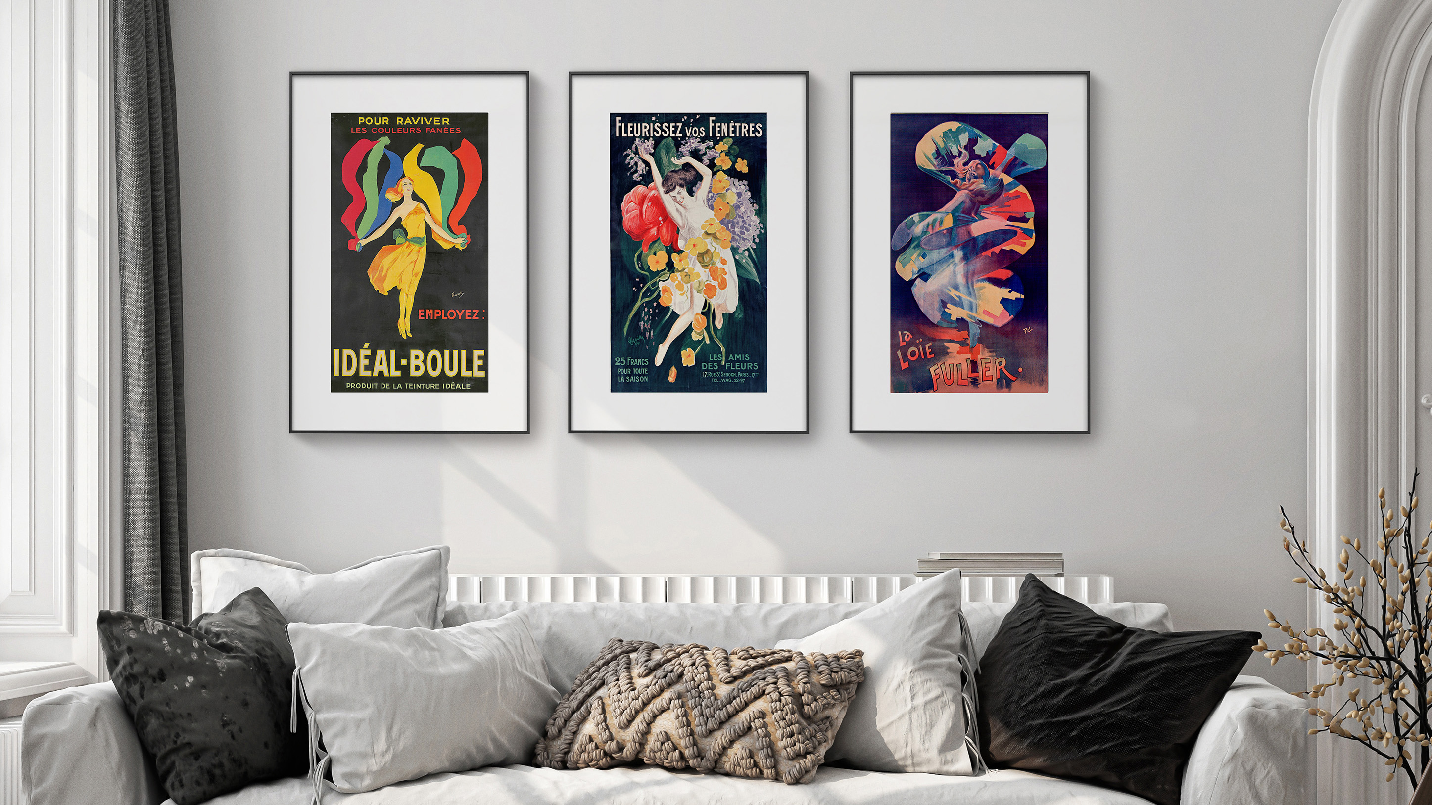 Three PocketBook InkPoster e-ink digital picture frames are displayed above a white couch