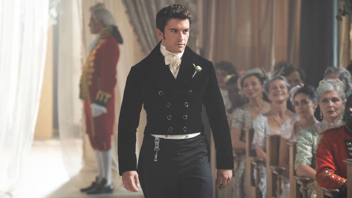 Jonathan Bailey as Anthony Bridgerton walking down an aisle at a ceremony in Season 2 of Bridgerton.