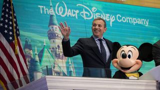 Chief executive officer and chairman of The Walt Disney Company Bob Iger and Mickey Mouse look on before ringing the opening bell at the New York Stock Exchange (NYSE), November 27, 2017 in New York City. Disney is marking the company's 60th anniversary as a listed company on the NYSE.